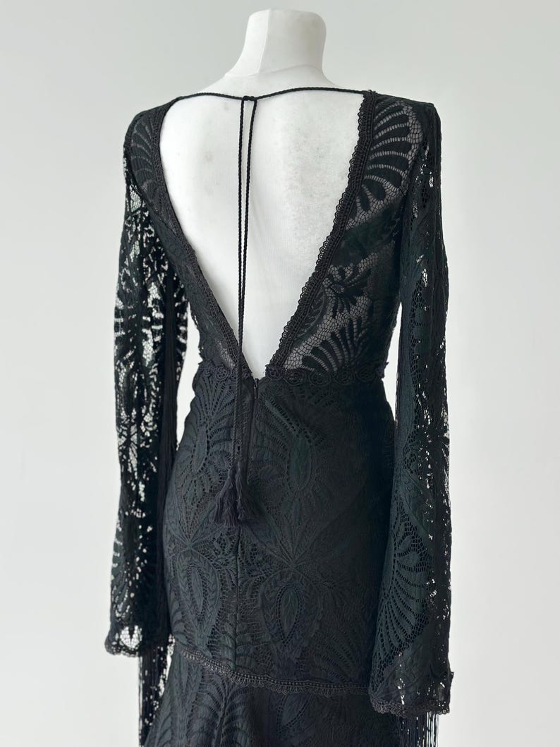 Black lace fringe tassel detail close up, 
dramatic lace texture evening gown fabric