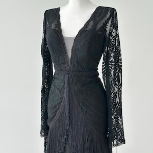 Black lace fringe tassel detail close up, 
dramatic lace texture evening gown fabric