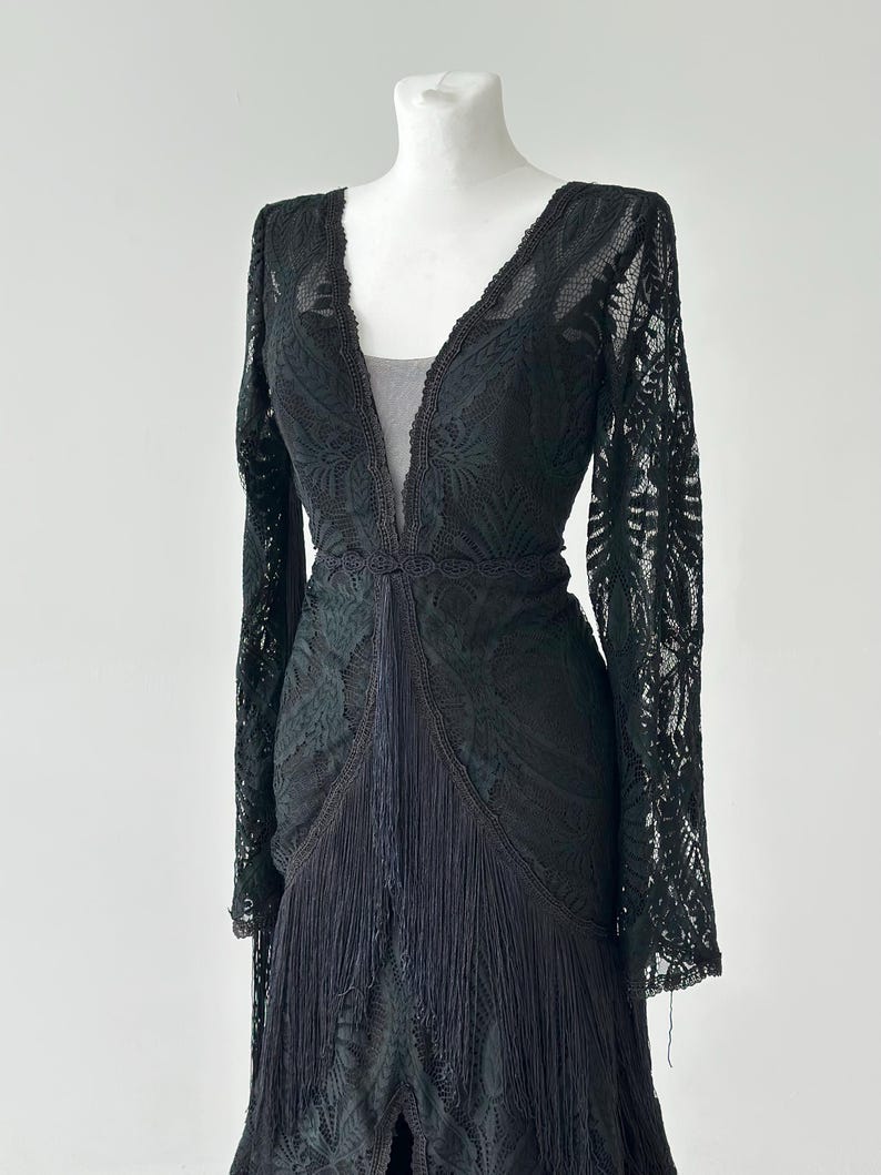 Black lace fringe tassel detail close up, 
dramatic lace texture evening gown fabric
