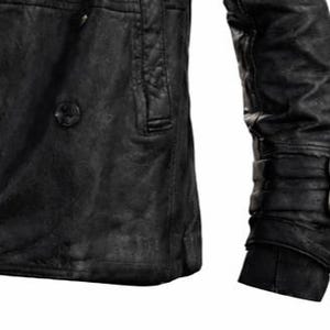 May include: Black leather jacket with a textured finish. The jacket features a double-breasted design with a single button closure and a small pocket. The sleeve has a cuff with two buckles. The jacket appears to be worn and distressed.