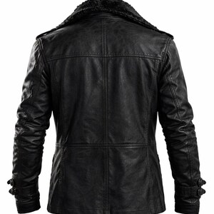 May include: Black leather jacket with a faux fur collar. The jacket has a classic design with a button closure and two side pockets. The sleeves are long and have buttoned cuffs. The jacket is made of a durable material and is suitable for cold weather.