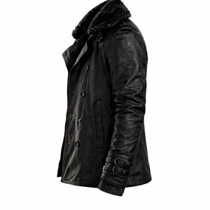 May include: Black leather jacket with a faux fur collar. The jacket features a double-breasted design with multiple buttons, a notched lapel, and a textured finish. The sleeves have buckle details near the cuffs. A classic outerwear piece.