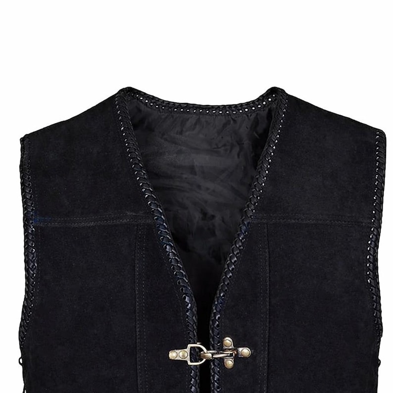 Close-up image of the upper front section of a black suede leather vest, highlighting antique brass hook closures and braided trim detail along the neckline. The soft suede texture and polyester inner lining are visible, emphasizing craftsmanship and durability for biker or casual wear.