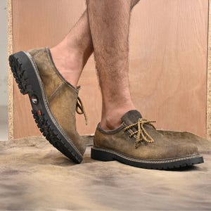 Traditional Bavarian suede leather shoes for men shown worn for indoor walking