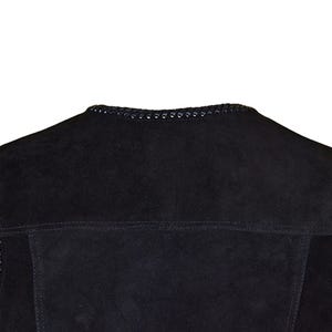 May include: Close-up of a black suede jacket collar. The collar is trimmed with a decorative, stitched design. The jacket has a classic, tailored look, with visible seams and a soft, textured appearance. The overall style suggests a focus on quality and craftsmanship.