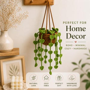 May include: A hanging crochet plant holder with a brown basket and green heart-shaped leaves. The text on the image says "PERFECT FOR Home Decor" and "BOHO • MINIMAL • COZY • HANDMADE". The bottom of the image says "NATURAL LOOK", "COZY VIBES", "PERFECT GIFT", and "HANDMADE WITH LOVE".