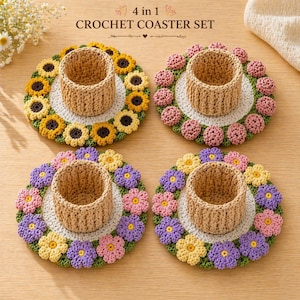 May include: A 4-in-1 crochet coaster set featuring four coasters with a floral design. Each coaster has a central woven basket. The coasters are decorated with yellow, pink, and purple crocheted flowers, and green leaves.