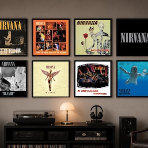 May include: Eight framed Nirvana album covers arranged in two rows on a wall. The collection includes Live at Reading, From the Muddy Banks of the Wishkah, Incesticide, a black logo print, Bleach, In Utero, MTV Unplugged in New York, and Nevermind.