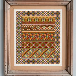 May include: A framed cross-stitch pattern featuring a colourful geometric design in shades of red, orange, yellow, green, and brown. The pattern is framed in a simple wooden frame.