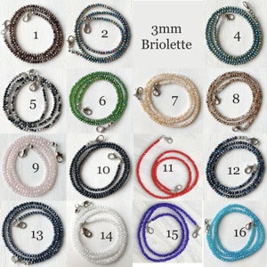May include: Sixteen different colors of 3mm briolette crystal bead chains. Each chain is approximately 28 inches long and features silver lobster clasps.