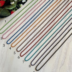 May include: Nine different colored chains of tiny round beads, each with a clasp at the end. The chains are numbered 1 through 9 and the text "Tiny Round Beads" is at the bottom of the image.