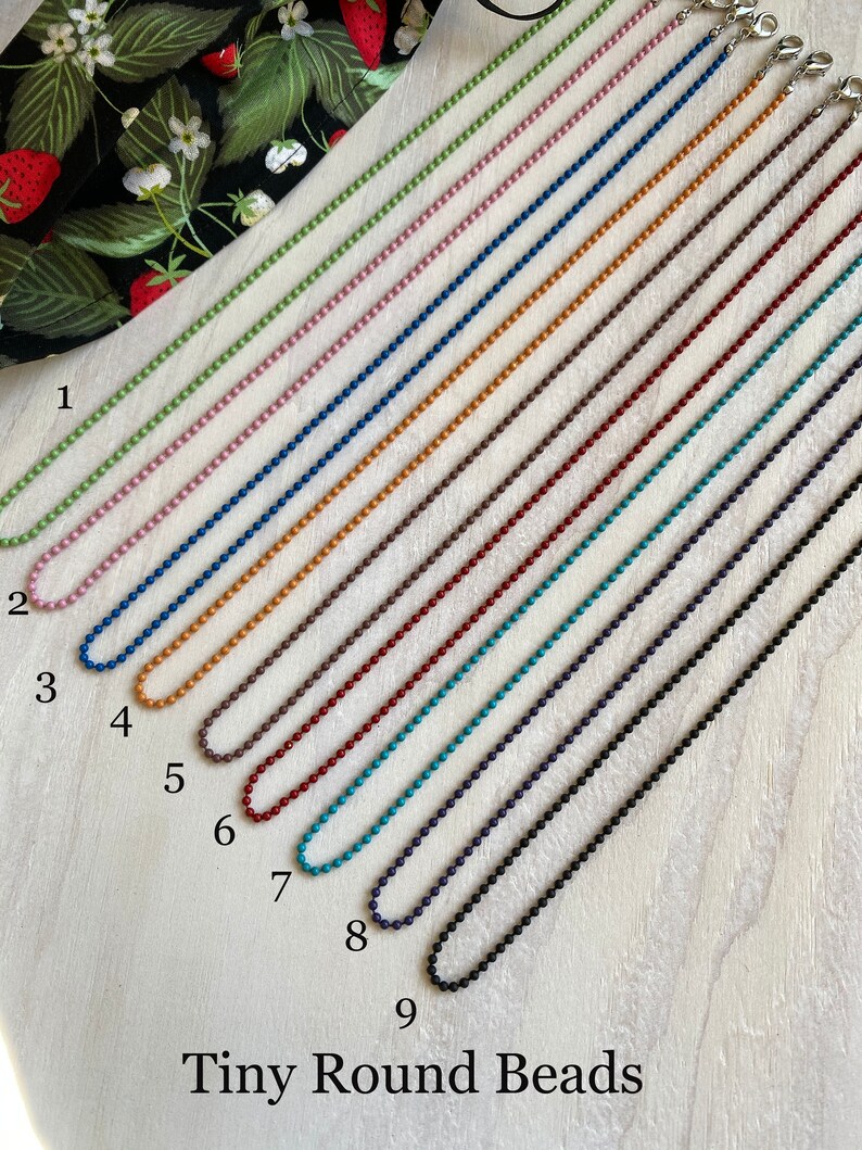 May include: Nine different colored chains of tiny round beads, each with a clasp at the end. The chains are numbered 1 through 9 and the text "Tiny Round Beads" is at the bottom of the image.