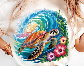 May include: Cream-colored t-shirt featuring a vibrant graphic of a sea turtle swimming in front of a large ocean wave. The design includes colorful hibiscus flowers and green seaweed, creating a tropical theme.