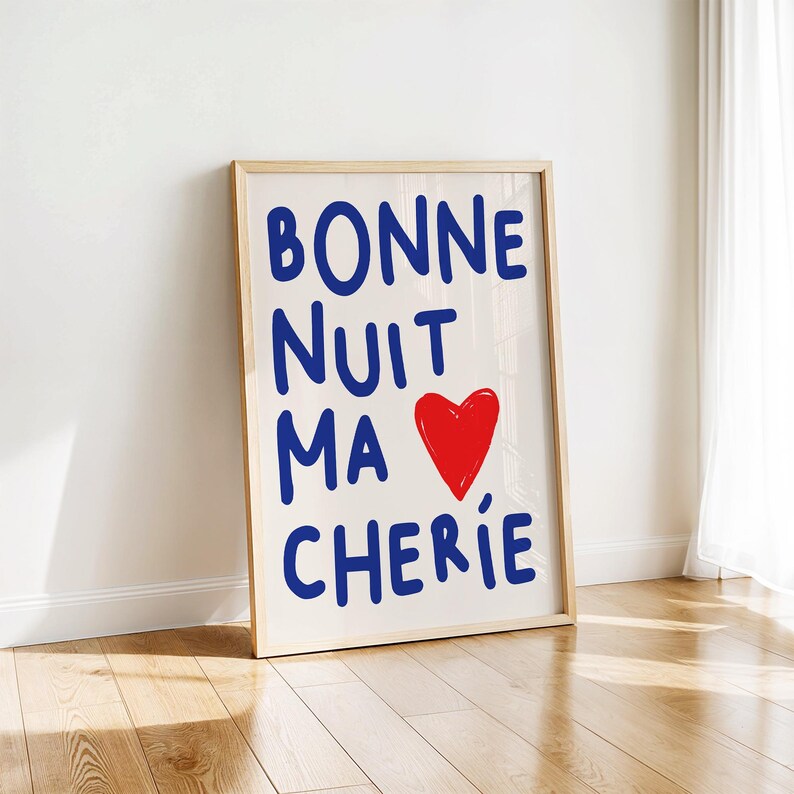 May include: A framed print with the text "BONNE NUIT MA CHERIE" in blue lettering and a red heart. The background is white.