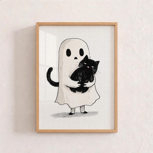 Peut inclure: Une impression d'art encadrée présentant une illustration en noir et blanc d'un fantôme portant un drap blanc avec deux trous pour les yeux, tenant un chat noir touffu dans ses bras. Le fantôme a une forme simple et arrondie.