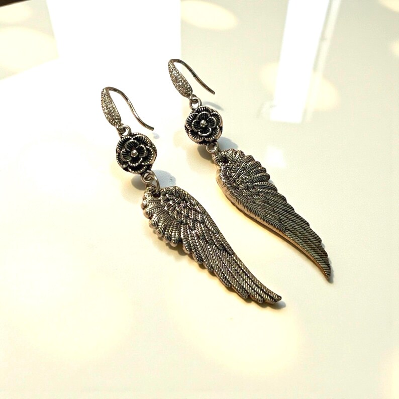 Gift Idea Collection Silver Angel Wing Earring Bohemian Dangle Design Floral Charm Accent Lightweight Statement Piece Wedding Guest Accessory Party Wear Essential Celestial Jewelry Trend Boho Style Fashion Special Occasion Must Have