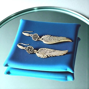 Gift Idea Collection Silver Angel Wing Earring Bohemian Dangle Design Floral Charm Accent Lightweight Statement Piece Wedding Guest Accessory Party Wear Essential Celestial Jewelry Trend Boho Style Fashion Special Occasion Must Have