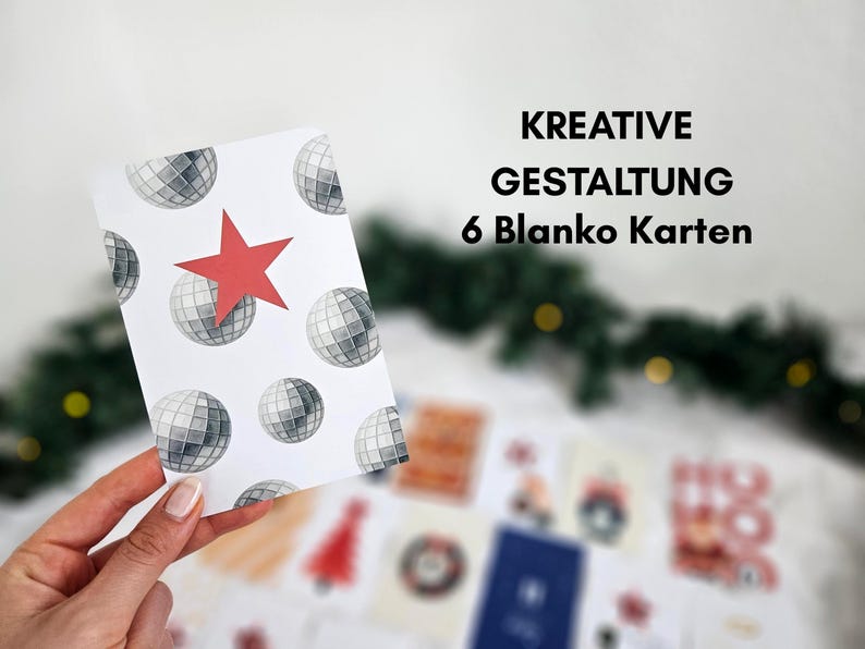 May include: A white card with a pattern of disco balls and a red star is held in front of other cards. The text "KREATIVE GESTALTUNG 6 Blanko Karten" is displayed in black. The cards are likely for a holiday or special occasion.