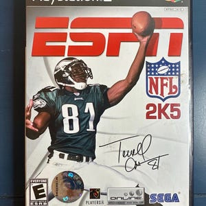 May include: A PlayStation 2 video game case for ESPN NFL 2K5. The cover features a football player in a green and white uniform catching a football. The game's title and the NFL logo are also visible.