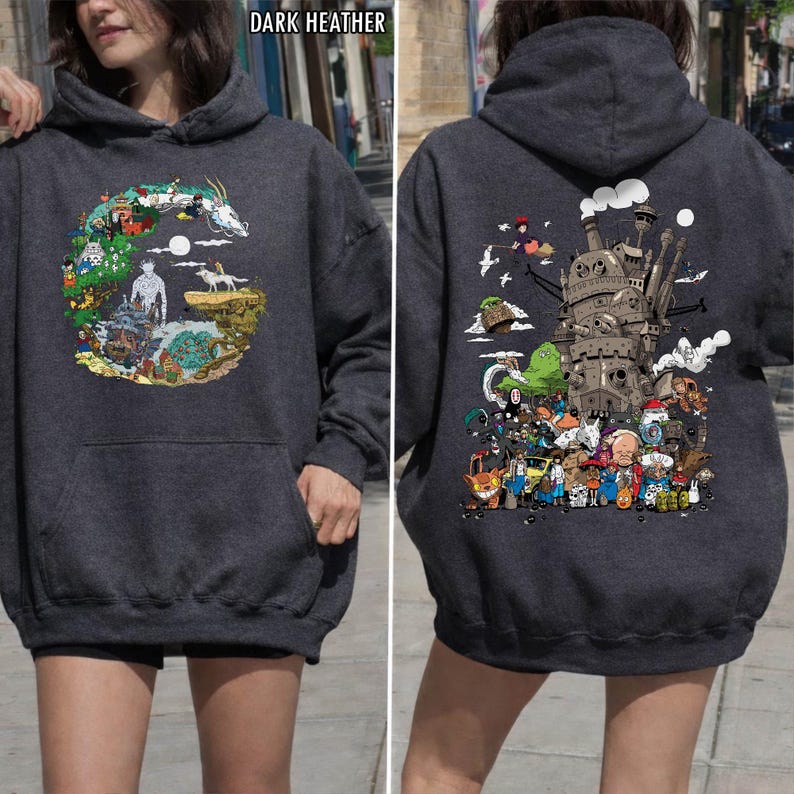 May include: Dark grey hoodie with a front pocket and hood. The front has a colourful illustration of characters and scenes. The back of the hoodie displays a detailed graphic of a castle and various animated figures.