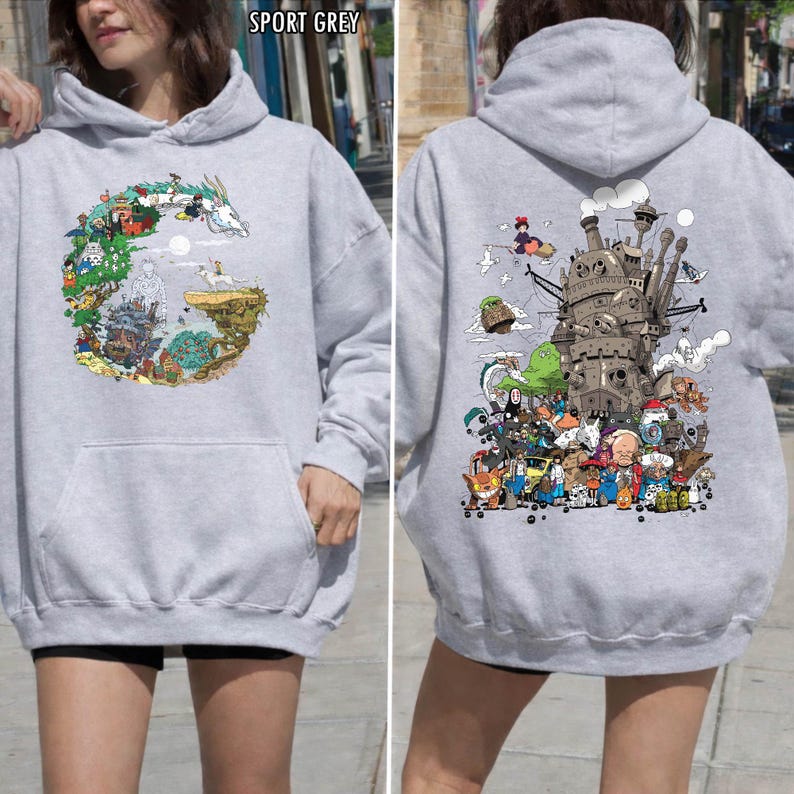 May include: Sport grey hoodie with front and back graphic designs. The front has a circular illustration with a dragon and characters. The back shows a detailed image of a castle and animated figures. The hoodie features a front pocket and a hood.