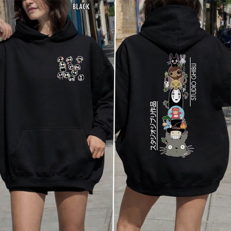 May include: Black hoodie featuring a front pocket and a hood. The front displays a cluster of cartoon characters. The back showcases a vertical stack of Studio Ghibli characters with Japanese text and the words "STUDIO GHIBLI".