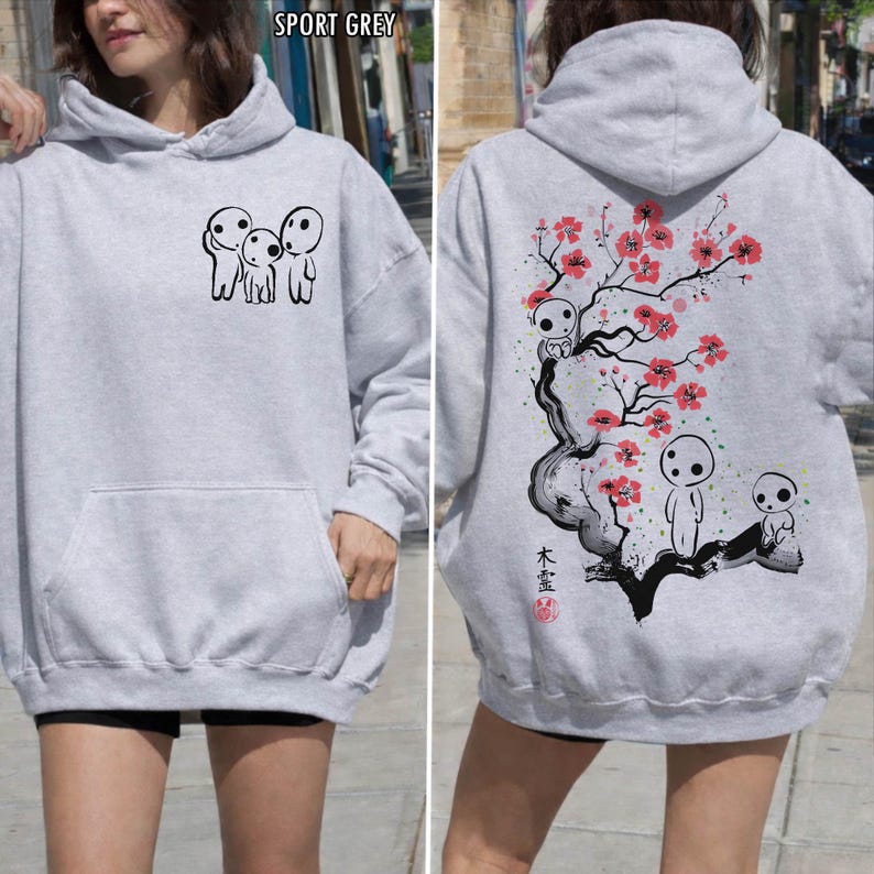 May include: Sport grey hoodie with a front pocket and a hood. The front features a black graphic of three small figures. The back displays a tree with red flowers and more figures, with Japanese text.
