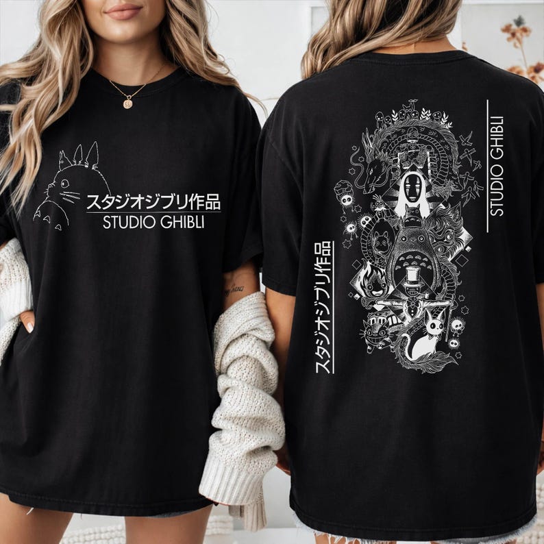 May include: Black t-shirt featuring a white graphic of a Studio Ghibli character on the front and a detailed illustration on the back. The text "スタジオジブリ作品 STUDIO GHIBLI" is printed on both sides.