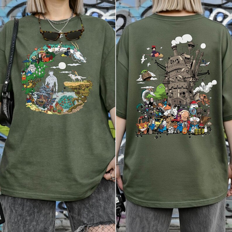 May include: Olive green t-shirt with a vibrant graphic on the front and back. The front design shows a circular landscape with fantastical creatures. The back features a detailed illustration of a castle and various characters.