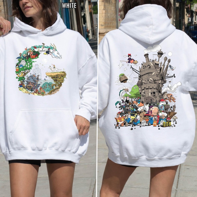 May include: White hoodie with vibrant illustrations from animated films. The front features a circular design with a dragon and characters. The back displays a detailed image of a castle and various characters. A comfortable, casual style.