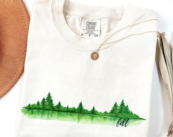 Maglietta FDT Subtle Protest – Maglietta femminista con foresta ad acquerello, maglietta politica anti-Trump ispirata alla natura, colori morbidi e confortevoli per la ribellione