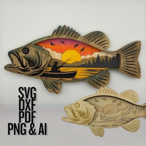 May include: Two wooden fish-shaped wall art pieces. The top one is stained with a dark wood finish and features a sunset scene with a fisherman in a boat. The bottom fish is a lighter wood with a similar design. Text: SVG DXF PDF PNG & AI.