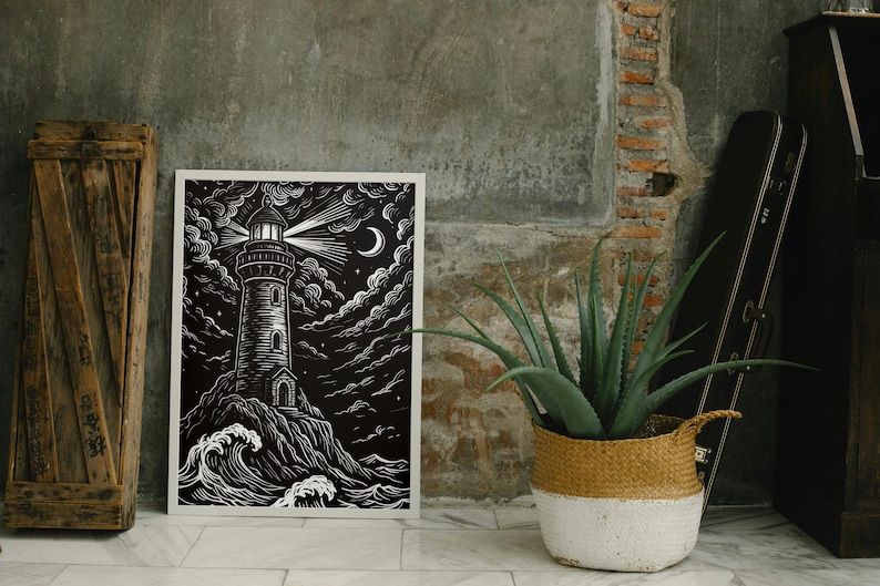 May include: Black and white art print of a lighthouse on a rocky shore under a starry sky. The lighthouse beam shines brightly, with a crescent moon visible. The artwork is framed in white.