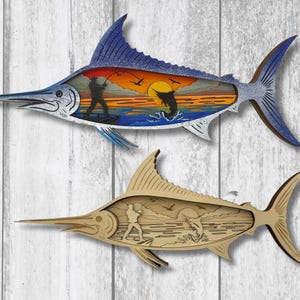 May include: Two wooden marlin fish wall art pieces. The top fish is blue and white with a sunset scene inside. The bottom fish is tan with a similar scene. Both have a fishing theme.