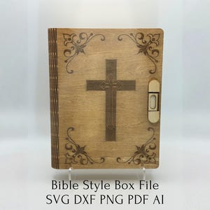 May include: Light brown wooden box featuring a cross design. The box has a cross etched in the centre, decorative corner flourishes, and a latch on the right. The text "Bible Style Box File" is at the bottom.