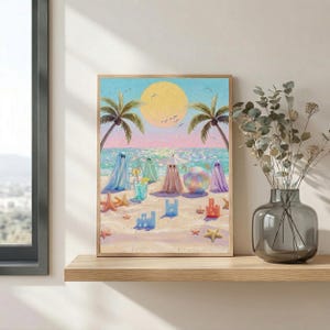 Tiny Ghosts Beach Day Wall Art shown on a minimalist wooden shelf paired with a glass vase of dried eucalyptus leaves. The soft pastel tones of the coastal scene and tiny ghosts create a whimsical yet sophisticated atmosphere in this sunlit modern living space. This lifestyle mockup demonstrates how the print fits into a serene, contemporary gallery wall for an everyday pop of color... — shop digital art instantly.
