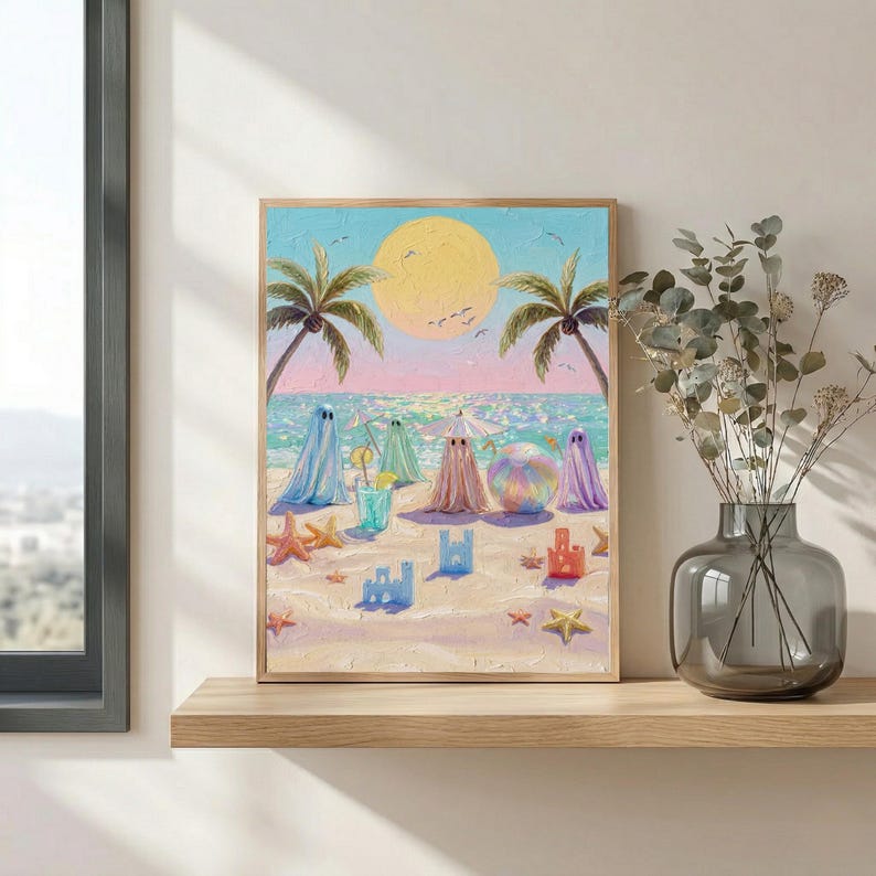 Tiny Ghosts Beach Day Wall Art shown on a minimalist wooden shelf paired with a glass vase of dried eucalyptus leaves. The soft pastel tones of the coastal scene and tiny ghosts create a whimsical yet sophisticated atmosphere in this sunlit modern living space. This lifestyle mockup demonstrates how the print fits into a serene, contemporary gallery wall for an everyday pop of color... — shop digital art instantly.