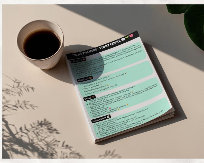 May include: A printed document titled "WHY I'M HERE" STORY CIRCLE with sections for Objective, Materials, Setup, and Instructions. The paper features a light green background with black text, bullet points, and small icons, placed next to a white cup of coffee.