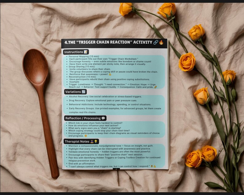 May include: A printed document titled 4. THE TRIGGER CHAIN REACTION ACTIVITY featuring instructions, variations, reflection questions, and therapist notes. A wooden spoon is placed to the left, and yellow roses are arranged on the right side.
