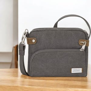 Bolso bandolera pequeño antirrobo Travelon para mujer: monedero de viaje con bloqueo RFID y compartimentos con cerradura