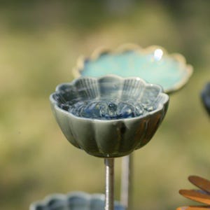 Handmade ceramic bird bath and feeder - a touch of farmhouse charm.