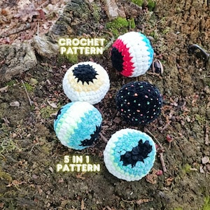 May include: Five colorful crochet balls with black, white, red, and blue accents are displayed on a mossy tree stump. The text "CROCHET PATTERN" and "5 IN 1 PATTERN" are visible. These handmade items are perfect for crafting.