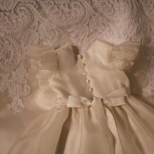 White lace and silk ivory organza with gathered flutter sleeves christening gown with sash