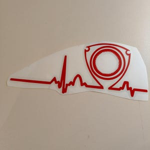 May include: Red vinyl decal of a stylized heart beat with a red rotary engine symbol inside. The decal is on a white background.