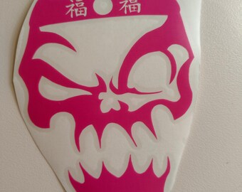 May include: Pink skull sticker with a white headband that says "福福" in Japanese characters.