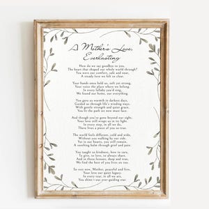 May include: A framed print with the poem "A Mother's Love, Everlasting" in elegant script. The poem is surrounded by a delicate floral border, and the frame is a warm, natural wood tone. The text is in a classic serif font.