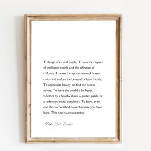 Puede incluir: Una impresi&oacute;n enmarcada con un marco de madera marr&oacute;n claro. La impresi&oacute;n presenta una cita de Ralph Waldo Emerson en texto negro sobre un fondo blanco. La cita trata sobre vivir una vida plena.