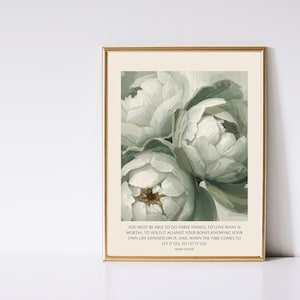 May include: A framed print featuring a close-up of white peony flowers with green leaves. The artwork has a soft, painterly style. The bottom of the print includes a quote by Mary Oliver.