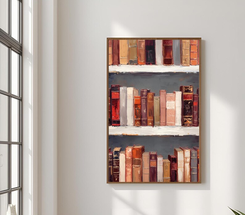 K&ouml;nnte beinhalten: Ein gerahmtes Kunstwerk, das ein B&uuml;cherregal mit alten B&uuml;chern zeigt. Die B&uuml;cher sind in verschiedenen Farben gehalten, darunter Rot, Braun und Beige. Das Kunstwerk hat einen dunkelgrauen Hintergrund und wei&szlig;e Regale.