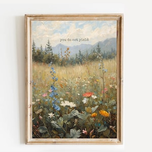 Puede incluir: Pintura de paisaje enmarcada que representa un prado de flores silvestres bajo un cielo nublado. La obra de arte incluye el texto "you do not yield" en la parte superior. La pintura está en un marco de madera, agregando un toque rústico.
